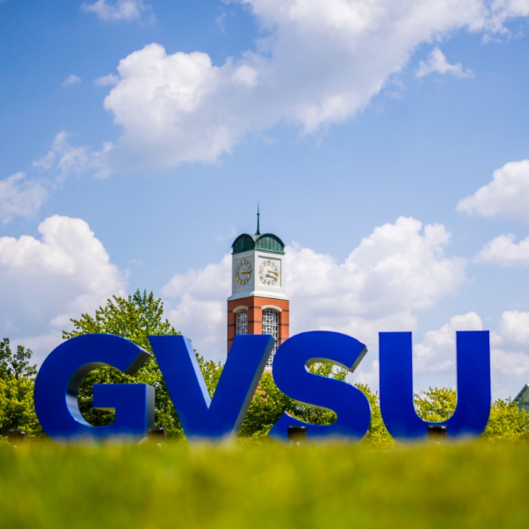 GVSU Letters in front of Cook Carillon Tower in the distance